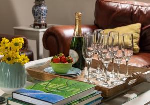 a table with wine glasses and a bottle of champagne at The Old Farmhouse in Michaelstow