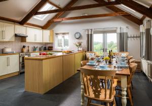a kitchen with a table and chairs in a kitchen at The Old Farmhouse in Michaelstow