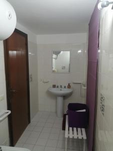 a bathroom with a sink and a toilet at Scrusciu do Mari in Butera