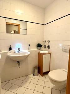 a bathroom with a sink and a toilet at FeWo Flair in Rottach-Egern