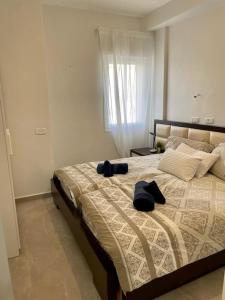 a bedroom with a large bed with two pillows on it at Gep's on Lachish in Beit Shemesh