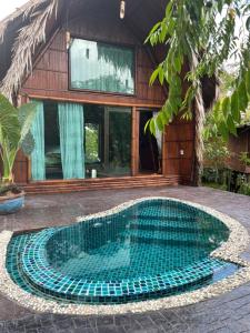 a swimming pool in front of a house at Villa Baan Pak Pra in Ban Pak Pra (1)