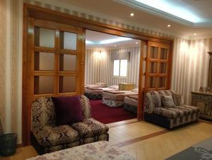 a room with a couch and a chair and a bed at Villa Marmara in Al Madinah