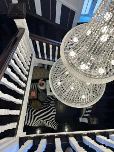 a staircase with two chandeliers and a zebra at Smithgrove Guesthouse in Pietermaritzburg