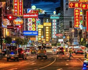 a busy city street at night with cars and signs at Chinatown Watmungkorn MRT Yaowaraj Bangkok in Bangkok
