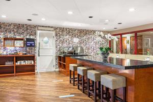 a kitchen with a counter and bar stools at Best Western Ta Inn Hotel in Västerås