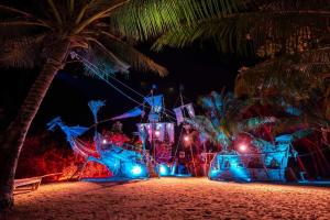 a house on the beach at night with lights at Hidden Beach Resort in Ko Mak
