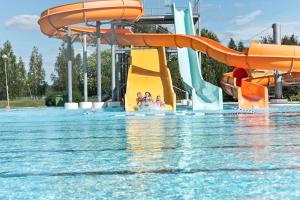 a water park with a water slide in the water at First Camp Björknäs-Boden in Boden