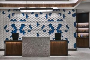 a lobby with a blue and white wall at Hyatt Place Wilmington Riverfront in Wilmington