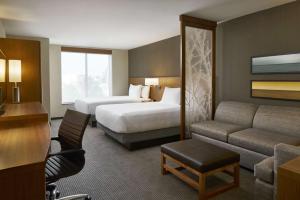una camera d'albergo con due letti e un divano di Hyatt Place Wilmington Riverfront a Wilmington