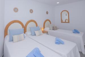 A bed or beds in a room at Poris 3 Beachfront Corralejo By Holidays Home