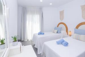 A bed or beds in a room at Poris 3 Beachfront Corralejo By Holidays Home