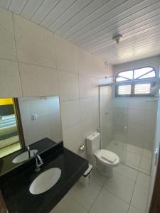 a bathroom with a sink and a toilet at Pousada Vitoria Aquiraz in Aquiraz