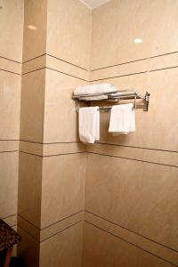a bathroom with white towels on a towel rack at Hotel Diamond Villa l Hotel Near Golden Temple Amritsar l Hotel In Amritsar l Best Hotel In Amritsar in Amritsar
