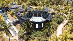 an aerial view of a resort with a pool and palm trees at Outrigger Mauritius Beach Resort in Bel Ombre