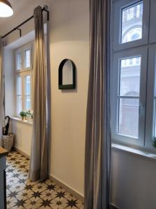 a bathroom with a shower curtain and a window at Studio apartment Frano in Zagreb