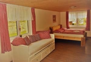 a bedroom with two beds and two windows at Penzion U Lípy in Ostrov