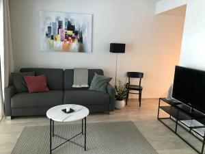 a living room with a couch and a table at Kaksio järvinäkymällä - Two room flat by the lake in Jyväskylä