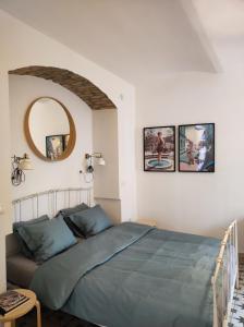 a bedroom with a bed and a mirror on the wall at Studio apartment Frano in Zagreb