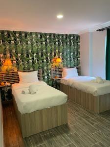 two beds in a room with a wall with plants at NAYADA OTEL SPA in Sapanca