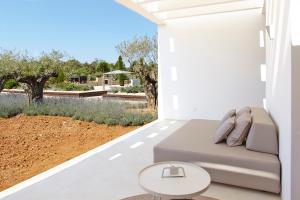 a living room with a couch and a table at Ca Na Xica - Hotel & Spa in Sant Miquel de Balansat