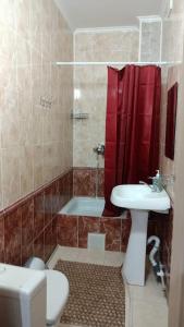 a bathroom with a toilet and a sink and a shower at Гостевой дом Самурук in Atyraū
