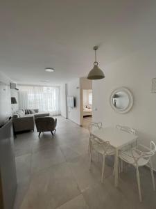 a living room with a table and chairs and a couch at Apartment Bliss in Bat Yam