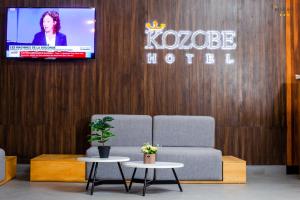 a room with two chairs and a tv on a wall at KOZOBE HÔTEL in Ambilobe