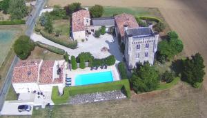 an aerial view of an old castle with a swimming pool at Aux 4 Cornes - Chambre d'hôtes in Longeves