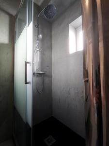 La salle de bains est pourvue d'une douche avec une porte en verre. dans l'établissement Brisa apart t2, à Ovar