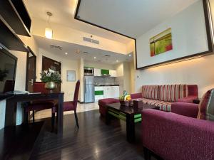 a living room with a couch and a table at Marina View Deluxe Hotel Apartment in Dubai