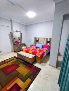 a bedroom with a bed and a mirror and a rug at Dreams House in Maadi in Cairo