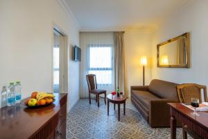 a living room with a couch and a table at Jerusalem Gold Hotel in Jerusalem