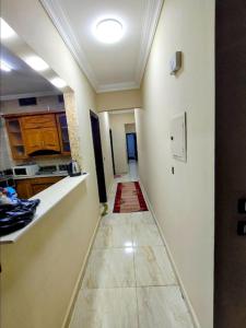 a hallway of a kitchen with a long hallwayngthngthngthngthngthngthngth at Dreams House in Maadi in Cairo