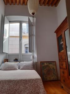 a bedroom with a bed and a window at CASA ARCO in Almería
