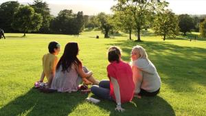 a group of people sitting on the grass in a park at Fairy Glen Guest Suite in Rostrevor