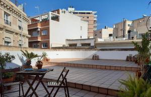 a patio with two chairs and a table on a building at CASA ARCO in Almería