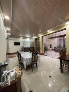 a dining room with a table and some chairs at Hotel Al Mansur in Bukhara
