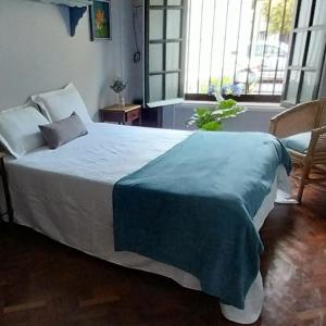 Un dormitorio con una cama con una manta azul. en Los Aceres en Salta