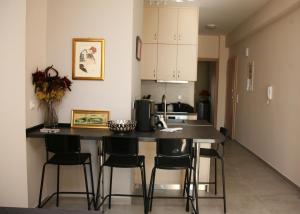 a kitchen with a counter and stools in a room at Lovely sea front apartment in Itea