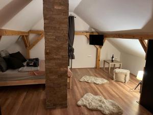 a attic room with a bed and a table at Vila Xenos Loft Karakter Zlatibor in Zlatibor