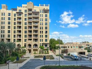 a large building with a parking lot in front of it at HiGuests - Charming Modern Apartment Close To The Souk in MJL in Dubai