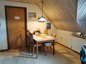 a dining room table with chairs and a wooden door at Annys Bed & Breakfast in Sunds