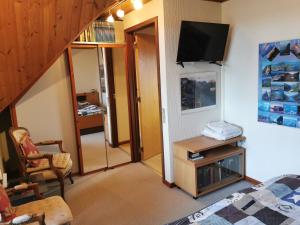 a room with a bed and a tv on a wall at Annys Bed & Breakfast in Sunds