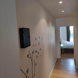 a room with a wall with butterflies on it at SMAK (Met ruim & rustig terras) in De Panne
