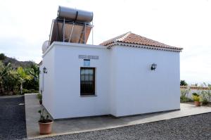 a white building with a telescope on top of it at Villa Estrella in Tijarafe
