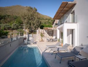 a villa with a swimming pool and a house at Sun Moon Villas, True Nature Purity, By ThinkVilla in Atsipádhes