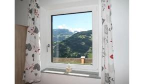 a window with a view of a mountain at Panorama Apart in Hippach