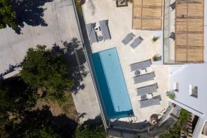 an overhead view of a swimming pool next to a building at Sun Moon Villas, True Nature Purity, By ThinkVilla in Atsipádhes