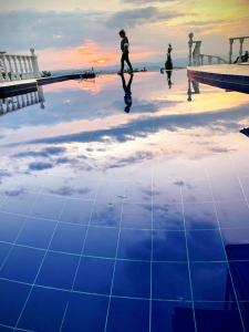 a reflection of a person walking in a pool at Villa NiNa in Manizales